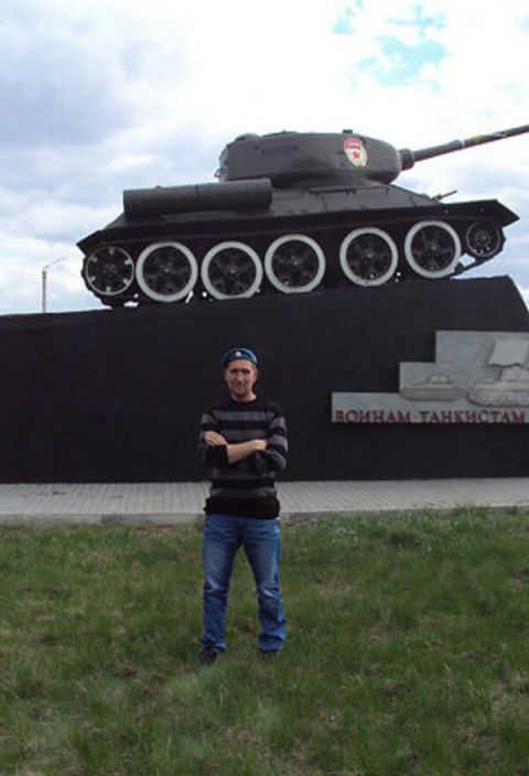 я стою один возле танка